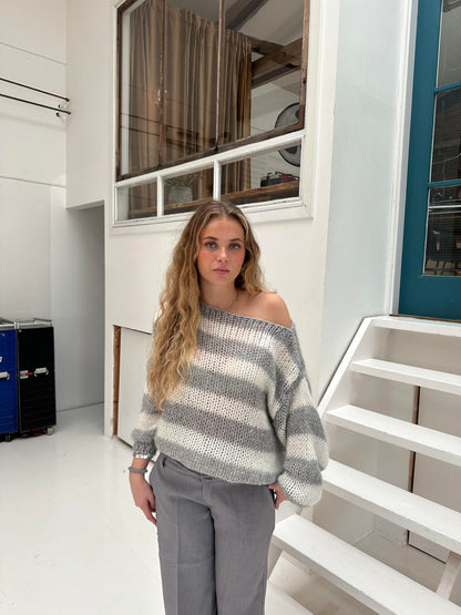 Model wearing the Sophia | Striped Knit Sweater, featuring bold stripes and a cozy, relaxed fit. Perfect for layering or wearing on its own, this sweater adds a touch of casual style to any outfit while keeping you warm and comfortable.