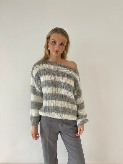 Model wearing the Sophia | Striped Knit Sweater, featuring bold stripes and a cozy, relaxed fit. Perfect for layering or wearing on its own, this sweater adds a touch of casual style to any outfit while keeping you warm and comfortable.