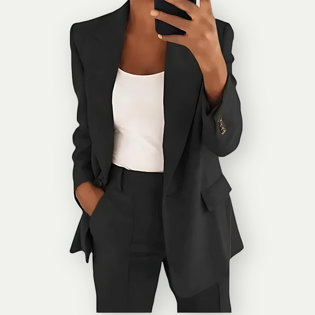 Woman wearing the Samantha Women's Tailored Blazer Set, featuring a fitted blazer with notch lapels and matching tailored pants, paired with a simple top, showcasing a chic and polished look perfect for both professional and casual occasions.