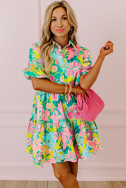 Back view of the Lily Women's Floral Tiered Dress, showcasing a vibrant floral pattern with tiered layers and short puff sleeves.