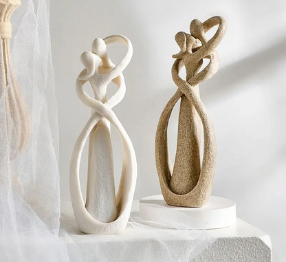 Elegant artistic sculptures showcasing intertwined figures, perfect for enhancing home décor with a touch of sophistication and timeless design.