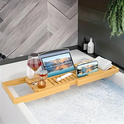 Bath tray with a multi-functional design holding a glass of wine, tablet, and smartphone on a bathtub, showcasing its compartments and adjustable layout for added convenience and relaxation.