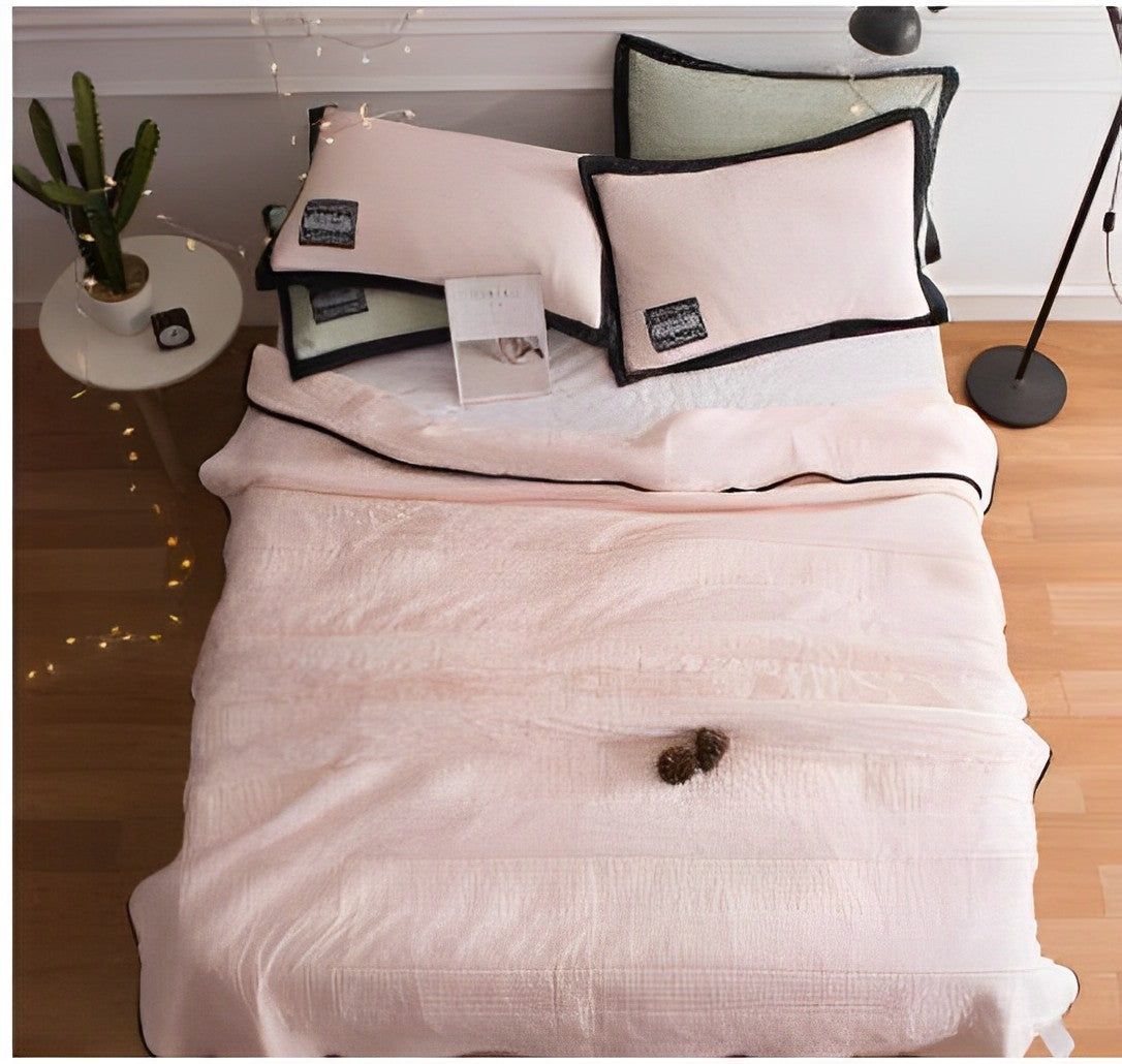 Woman peacefully sleeping wrapped in an ultra-soft blanket, showcasing its cozy and luxurious texture on a neatly made bed.