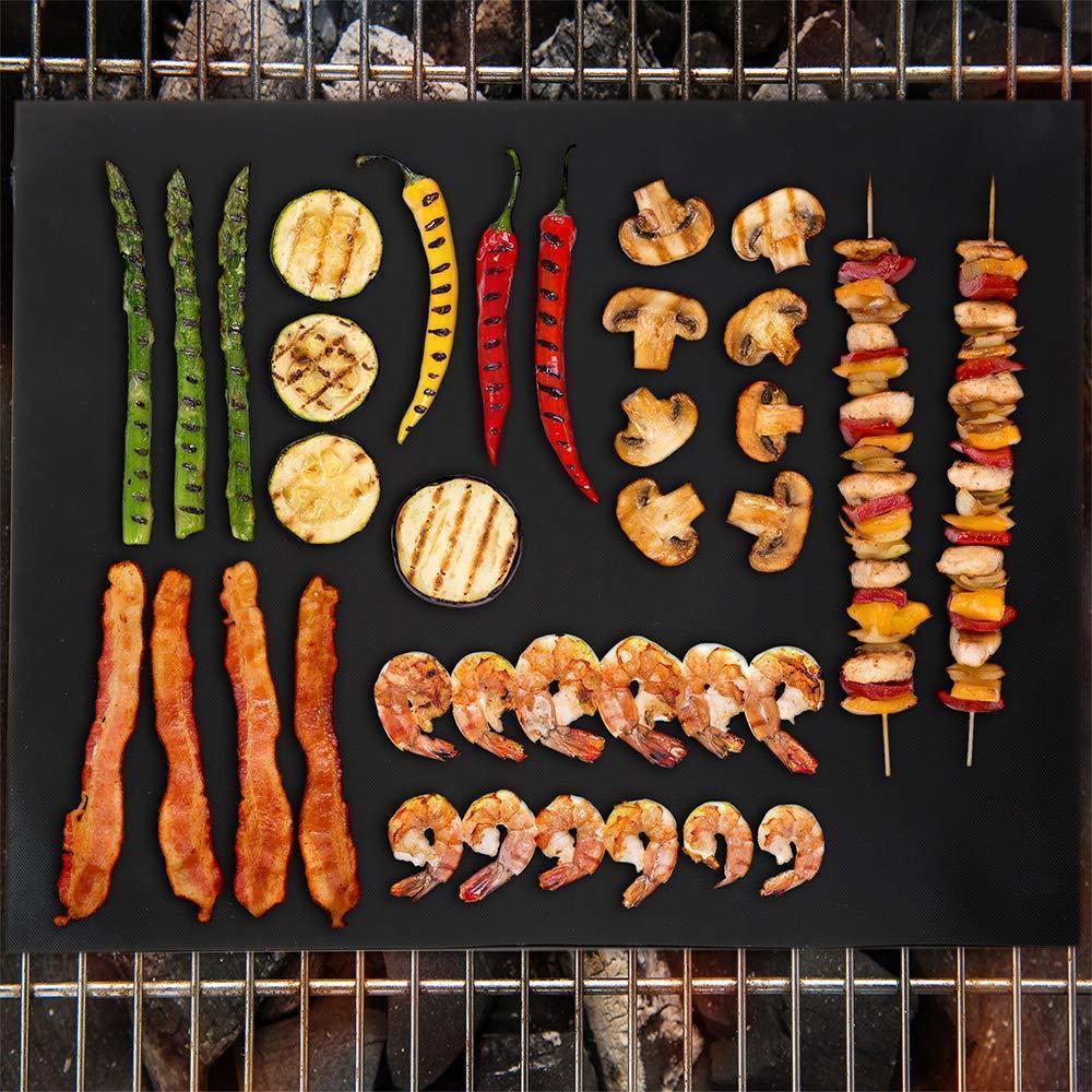 Non-stick grill mat placed on a barbecue grill with grilled salmon fillets and lemon slices, showcasing even cooking and ease of use.