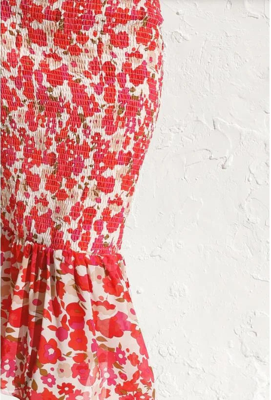 A stylish woman wearing the Emma | Women's Backless Midi Dress | Elegant Floral Dress, showcasing its elegant backless design and flattering midi length. The dress features long sleeves and a fitted waist, creating a sophisticated and graceful look.