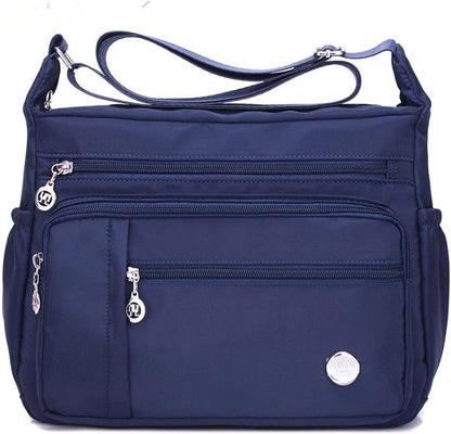  Functional multi-pocket bag with adjustable strap, multiple zippered compartments, and side pockets, offering ample space for daily essentials. Compact and lightweight design for easy carrying. Perfect for organization and travel use.
