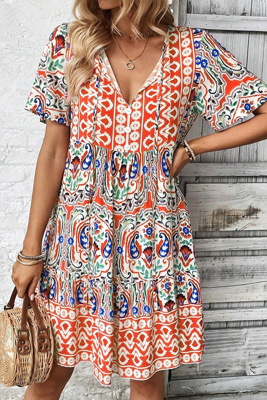 Model wearing the Sienna Women's Boho Print Dress, showcasing a relaxed fit and intricate bohemian-inspired patterns. The dress features a deep V-neckline, short sleeves, and a flowy, casual design ideal for warm-weather outings.