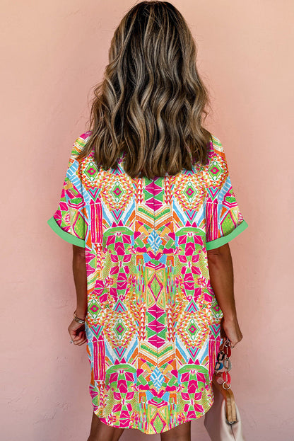 Woman wearing the Zara Women's Geometric Button-Down Dress with a vibrant pattern, accessorized with a handbag and bold jewelry. The dress features a relaxed fit and geometric design, perfect for a stylish and casual look.