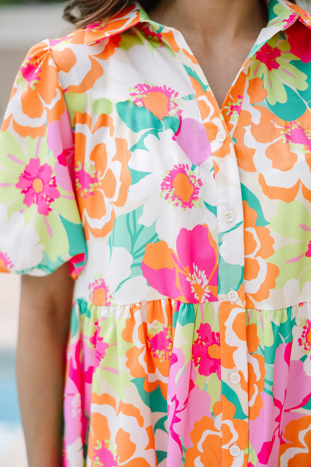 Back view of the Lily Women's Floral Tiered Dress, showcasing a vibrant floral pattern with tiered layers and short puff sleeves.