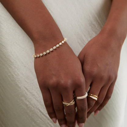 Woman smiling while showcasing the Amelia Women's Classic Bracelet, elegantly worn on her wrist. The bracelet's timeless design adds a touch of sophistication to her outfit, perfect for any occasion.