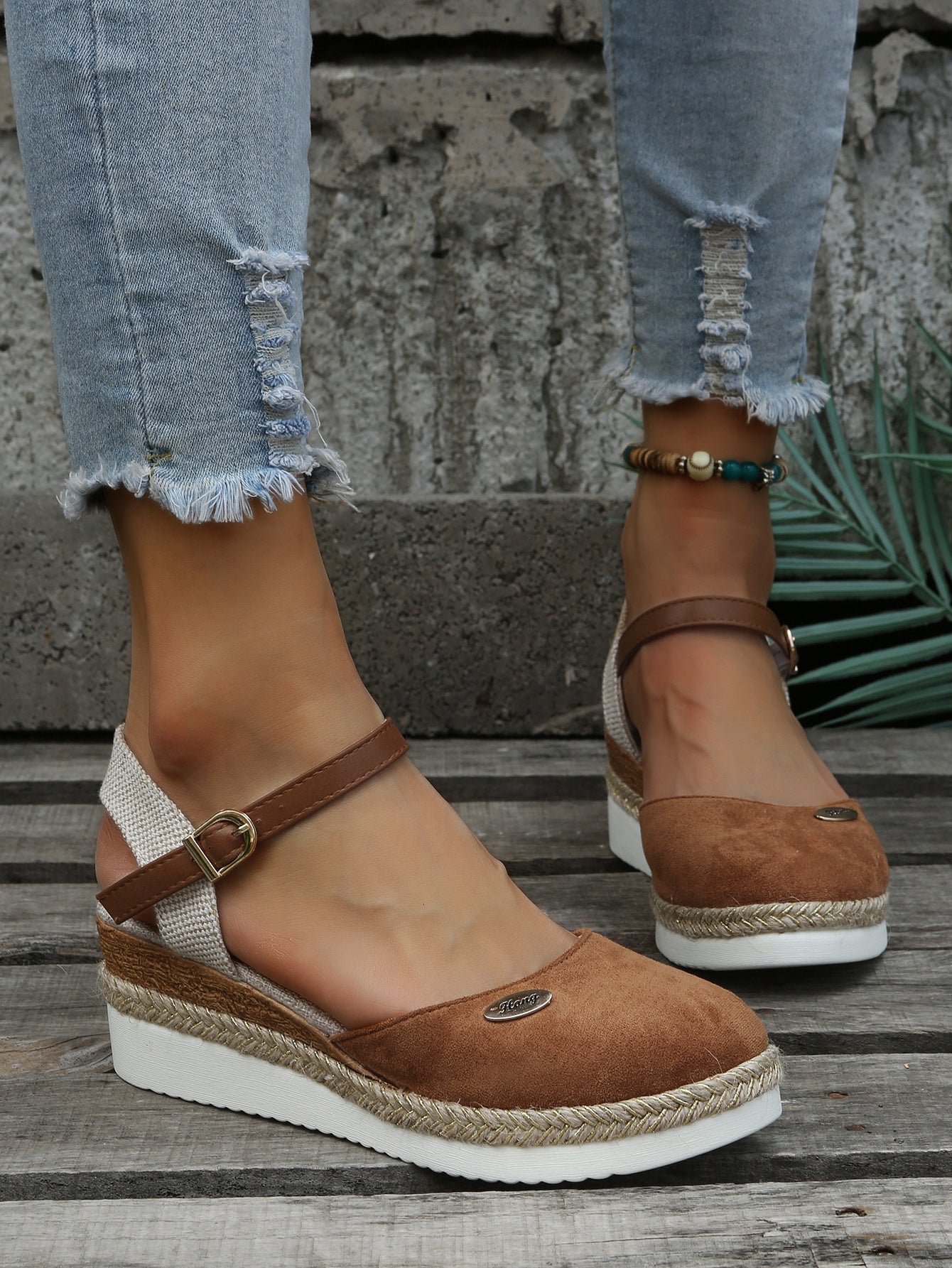 An image showcasing stylish women's wedge sandals with a comfortable design, featuring adjustable ankle straps and a supportive sole, perfect for casual or semi-formal outings.