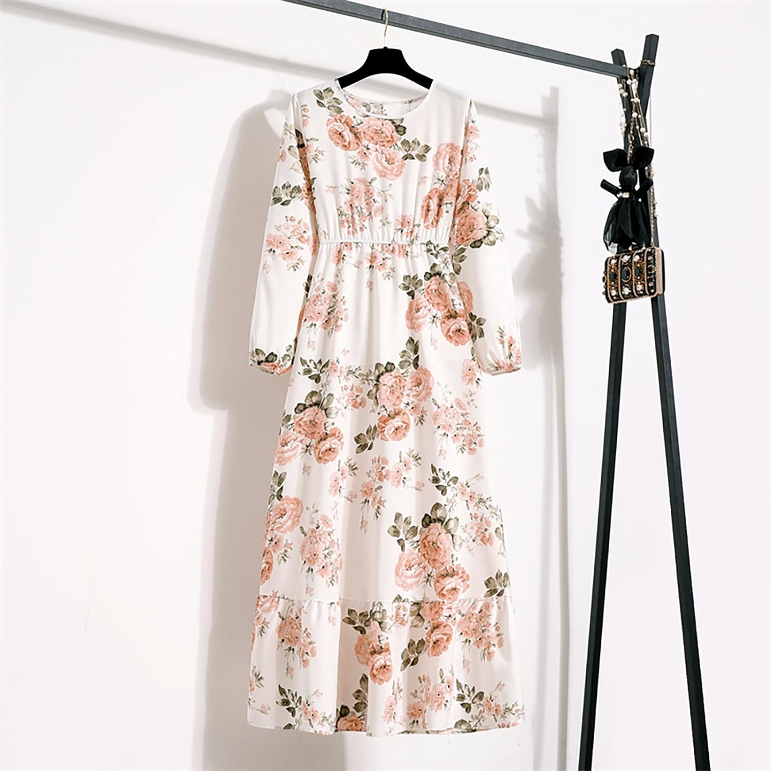 Woman wearing the Camilla Women's Floral Maxi Dress, a long dress with a flowy silhouette and elegant floral design, styled with long sleeves and paired with strappy heels, standing outdoors in a sunny, stylish setting.