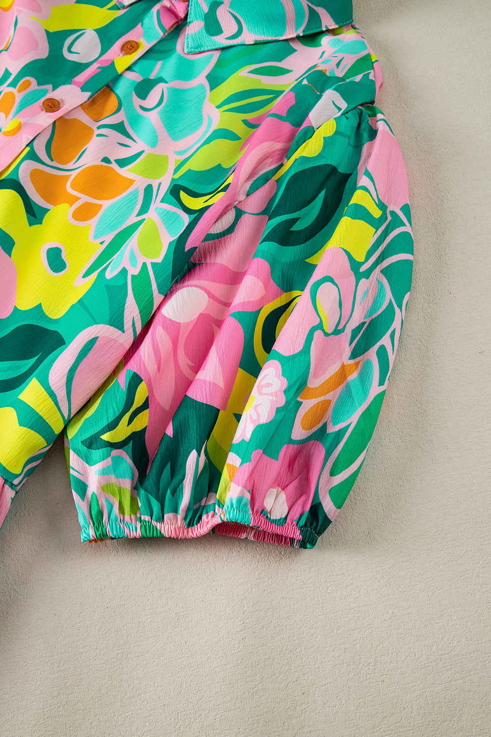 Back view of the Lily Women's Floral Tiered Dress, showcasing a vibrant floral pattern with tiered layers and short puff sleeves.