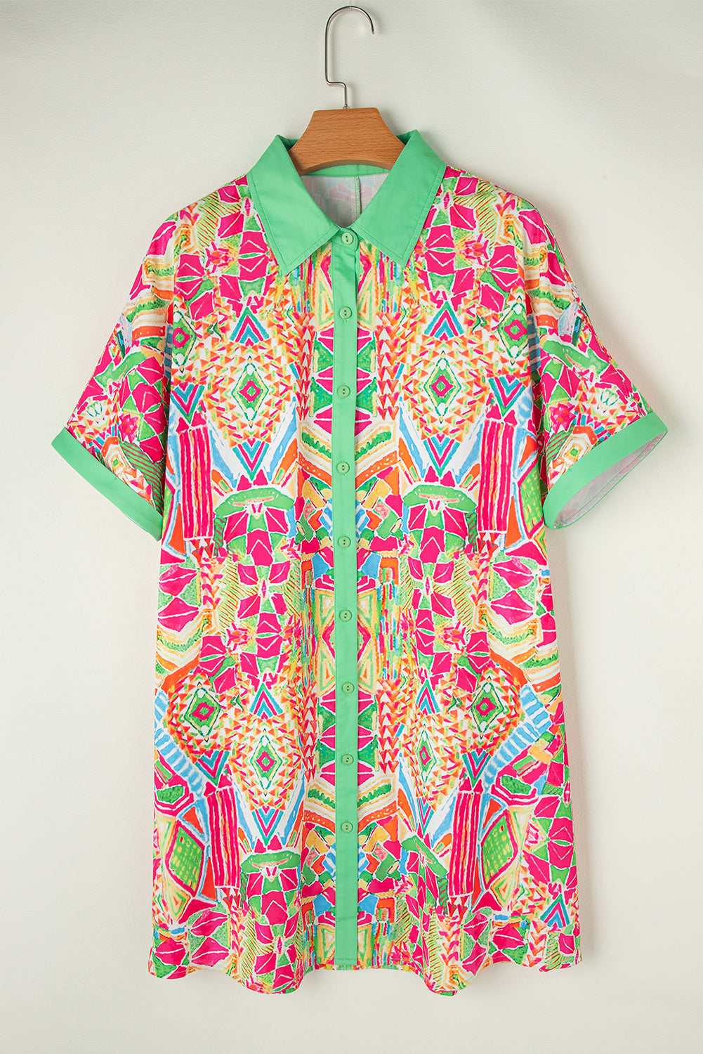 Woman wearing the Zara Women's Geometric Button-Down Dress with a vibrant pattern, accessorized with a handbag and bold jewelry. The dress features a relaxed fit and geometric design, perfect for a stylish and casual look.