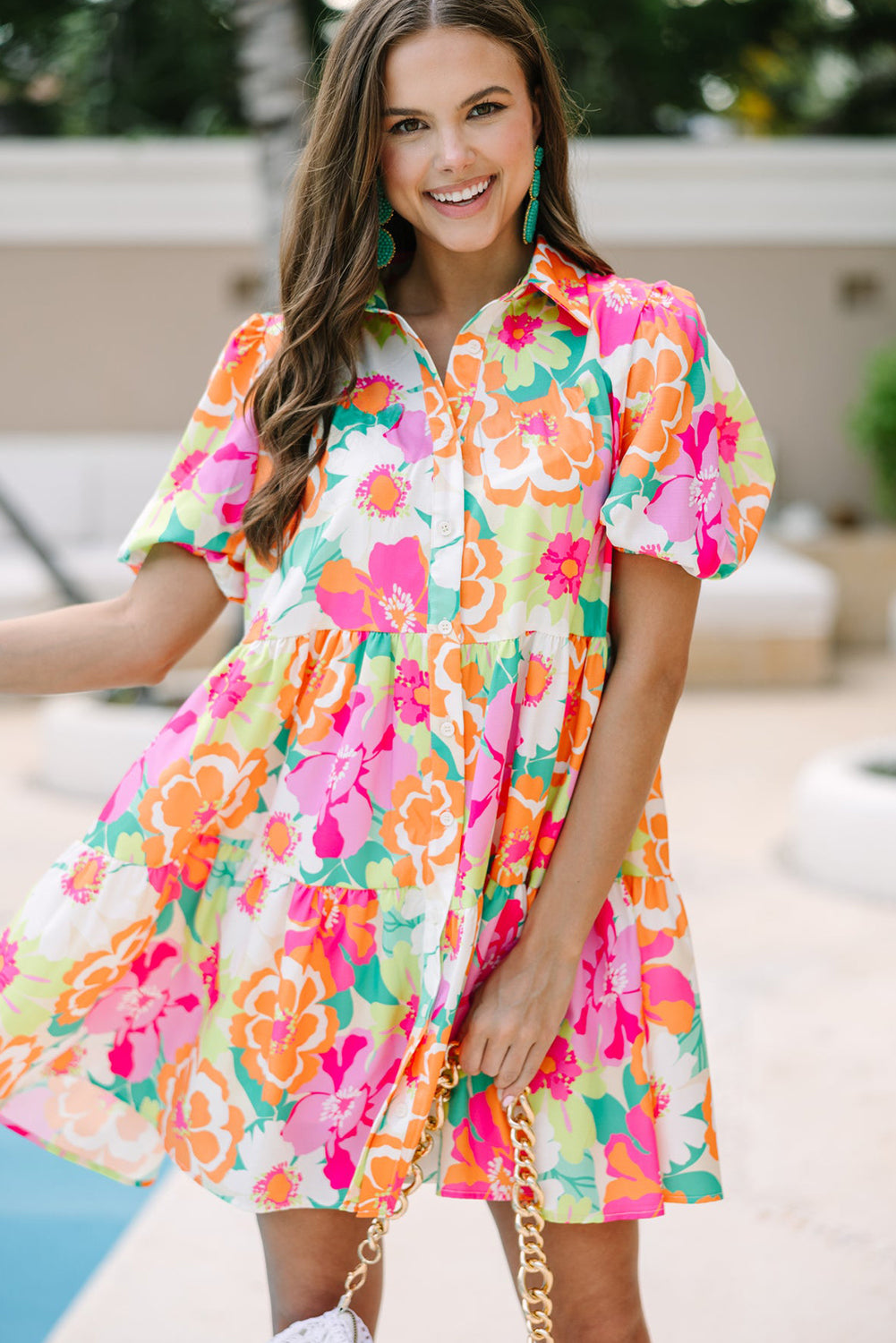 Back view of the Lily Women's Floral Tiered Dress, showcasing a vibrant floral pattern with tiered layers and short puff sleeves.