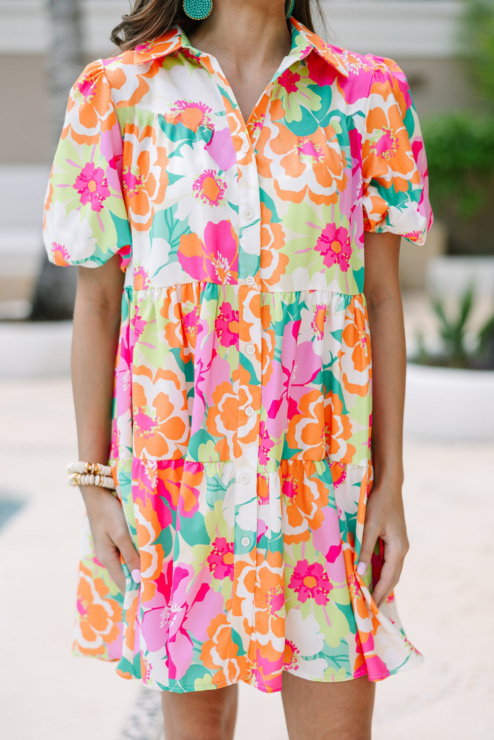 Back view of the Lily Women's Floral Tiered Dress, showcasing a vibrant floral pattern with tiered layers and short puff sleeves.