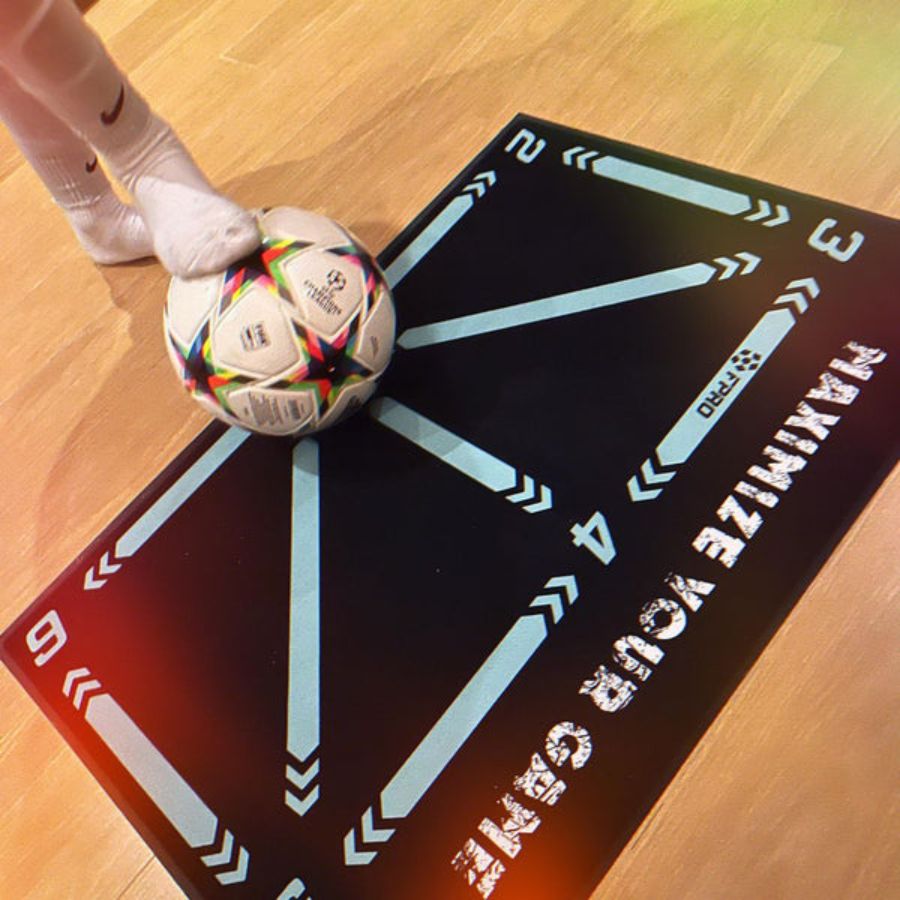 Person using an athletic trainer mat with a ball, showcasing its design for improving coordination, agility, and footwork during training sessions.