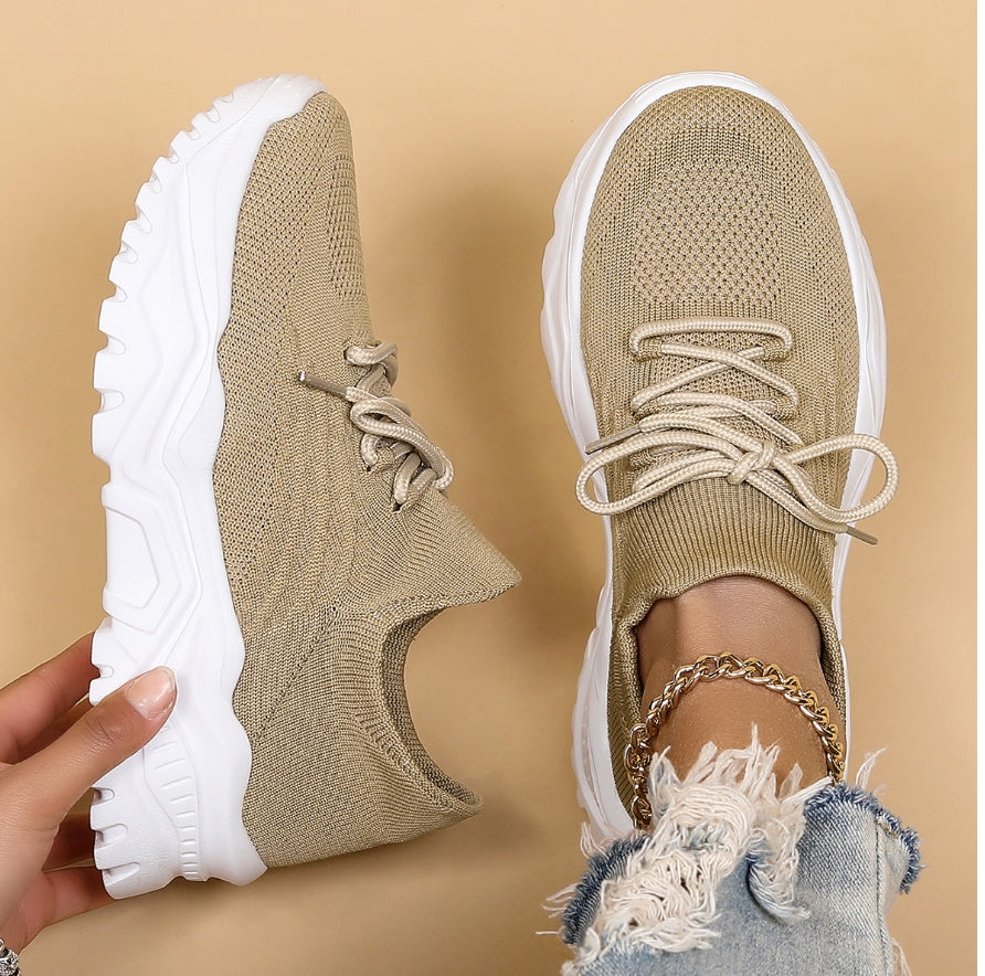 Image showcasing a pair of breathable women's sneakers with a sleek and lightweight design, featuring lace-up closure and a comfortable sole, ideal for casual wear and active lifestyles.
