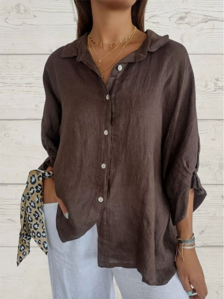 A relaxed-fit women's blouse with a button-up front, long sleeves, and a lightweight, flowy design, styled casually for versatile wear.