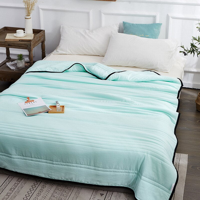 Woman peacefully sleeping wrapped in an ultra-soft blanket, showcasing its cozy and luxurious texture on a neatly made bed.