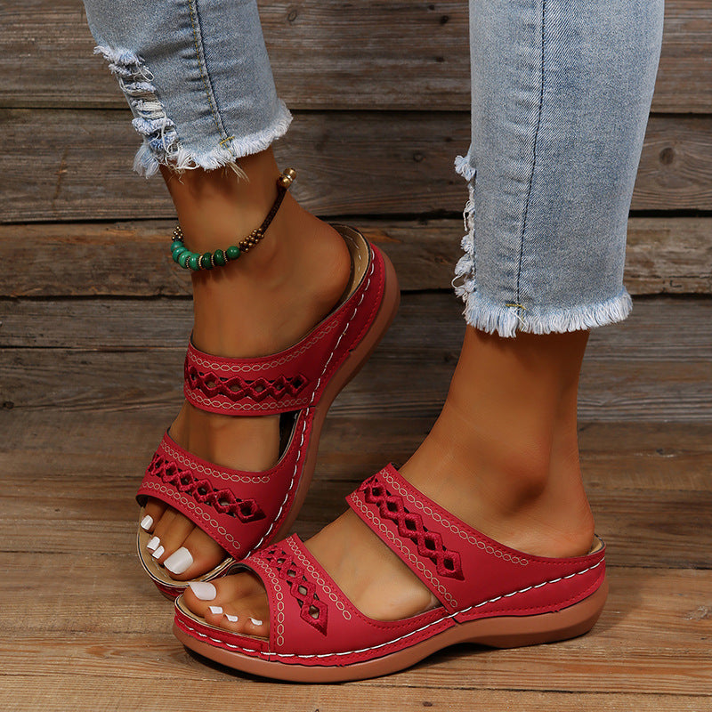 A pair of Ella Women's Stylish Slip-On Sandals with a unique cut-out design and cushioned sole, worn by a person. These sandals offer a comfortable fit and trendy look, perfect for casual and warm-weather outfits.