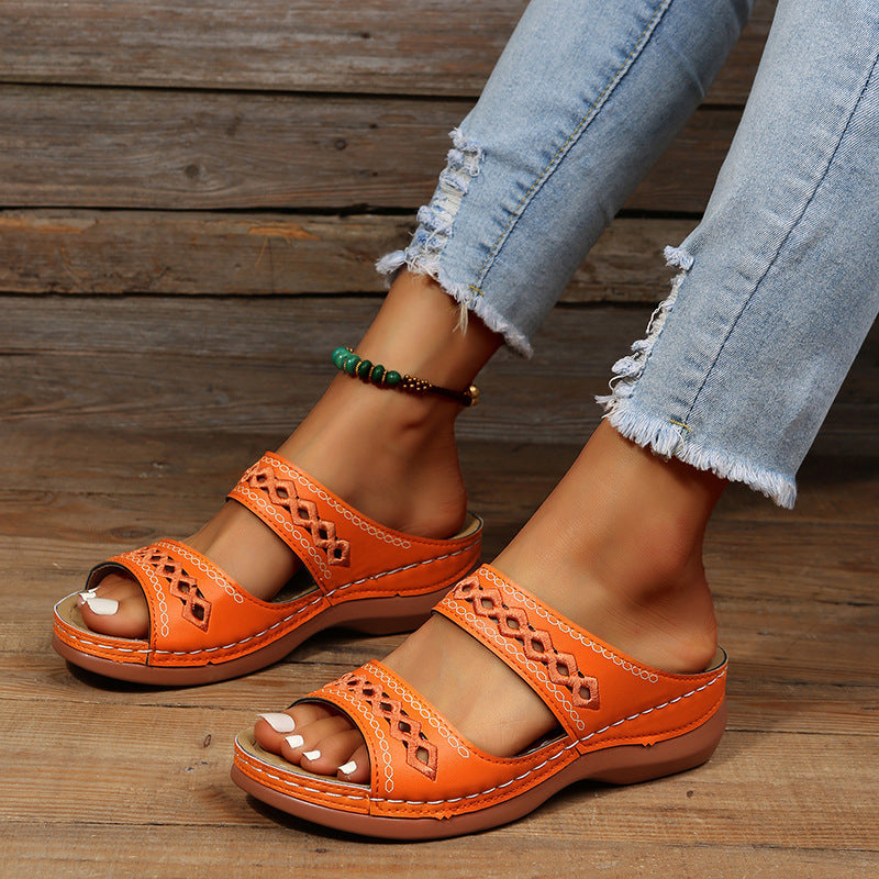 A pair of Ella Women's Stylish Slip-On Sandals with a unique cut-out design and cushioned sole, worn by a person. These sandals offer a comfortable fit and trendy look, perfect for casual and warm-weather outfits.