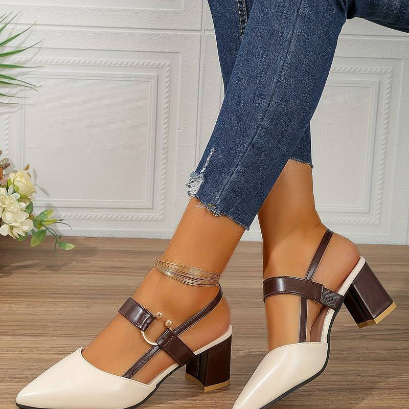  A pair of Sophia Women's Elegant Block Heel Shoes with a stylish double-strap design and pointed toe, worn by a person. These heels feature a comfortable block heel, perfect for adding elegance to both casual and formal outfits.