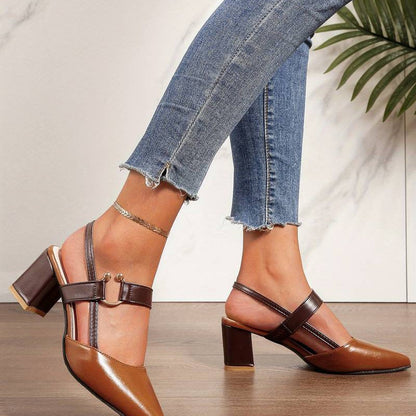  A pair of Sophia Women's Elegant Block Heel Shoes with a stylish double-strap design and pointed toe, worn by a person. These heels feature a comfortable block heel, perfect for adding elegance to both casual and formal outfits.