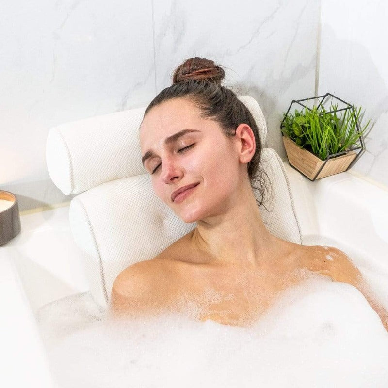 Bath pillow with ergonomic design featuring a cushioned headrest and padded back support, placed on a bathtub for enhanced comfort and relaxation.