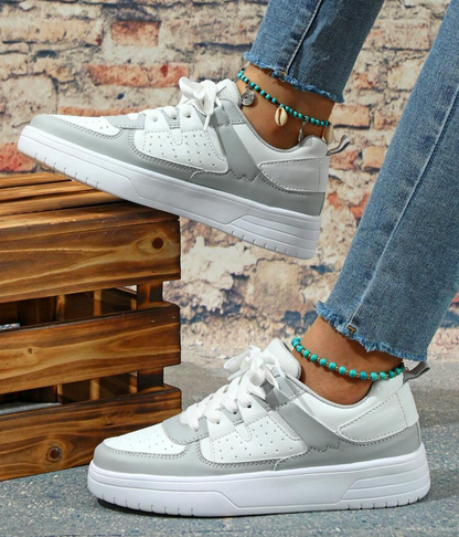 Women's casual sneakers with a modern design, featuring lace-up closure and a comfortable fit for everyday wear.