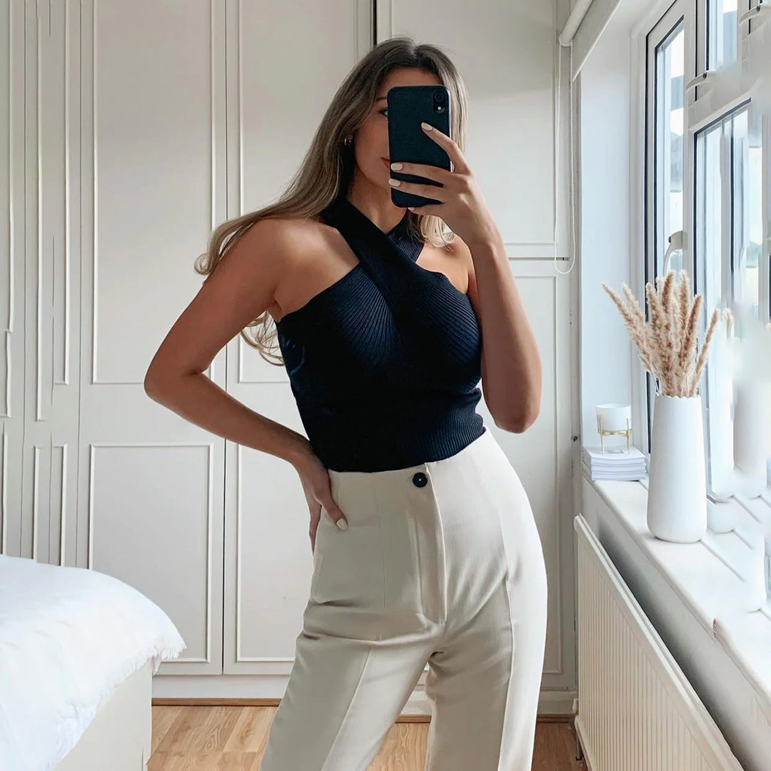 Women's elegant halter top with a fitted design, featuring a cross-over neckline for a stylish and sophisticated look.