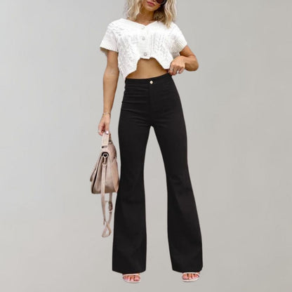 A woman modeling high-waisted flared pants paired with a cropped knit top and a stylish handbag, showcasing the chic and versatile design of the Lila | Women's High-Waisted Flared Pants | Chic Corduroy Trousers.