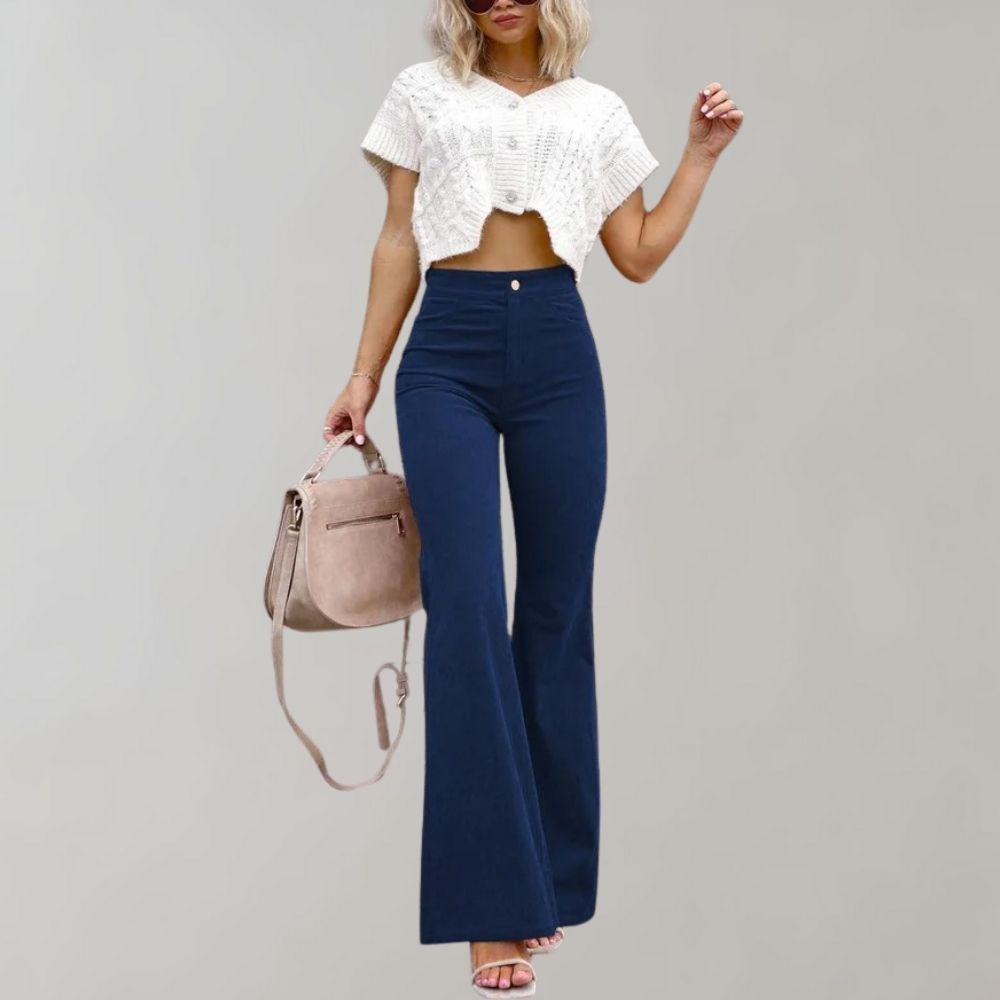 A woman modeling high-waisted flared pants paired with a cropped knit top and a stylish handbag, showcasing the chic and versatile design of the Lila | Women's High-Waisted Flared Pants | Chic Corduroy Trousers.