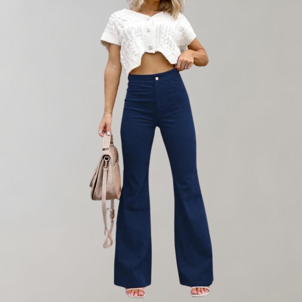 A woman modeling high-waisted flared pants paired with a cropped knit top and a stylish handbag, showcasing the chic and versatile design of the Lila | Women's High-Waisted Flared Pants | Chic Corduroy Trousers.