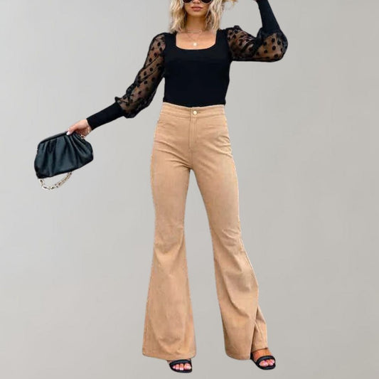 A woman modeling high-waisted flared pants paired with a cropped knit top and a stylish handbag, showcasing the chic and versatile design of the Lila | Women's High-Waisted Flared Pants | Chic Corduroy Trousers.