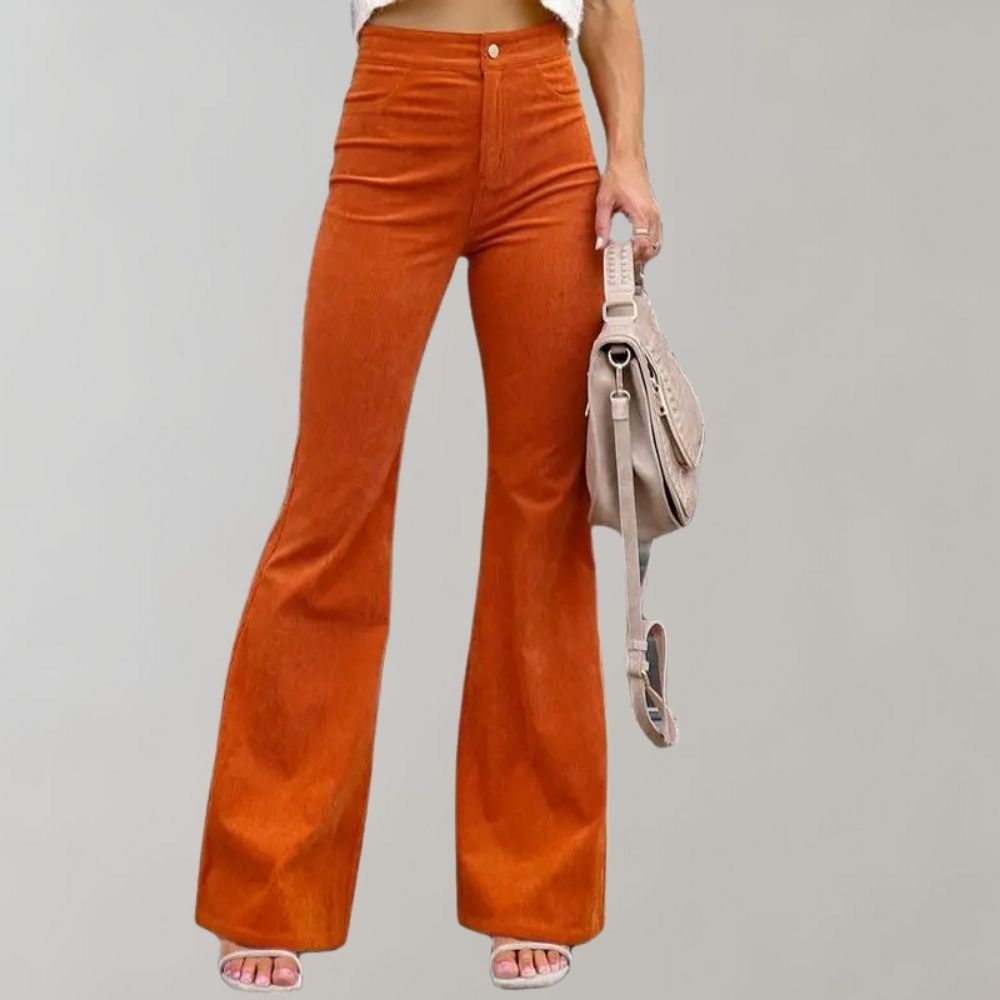 A woman modeling high-waisted flared pants paired with a cropped knit top and a stylish handbag, showcasing the chic and versatile design of the Lila | Women's High-Waisted Flared Pants | Chic Corduroy Trousers.