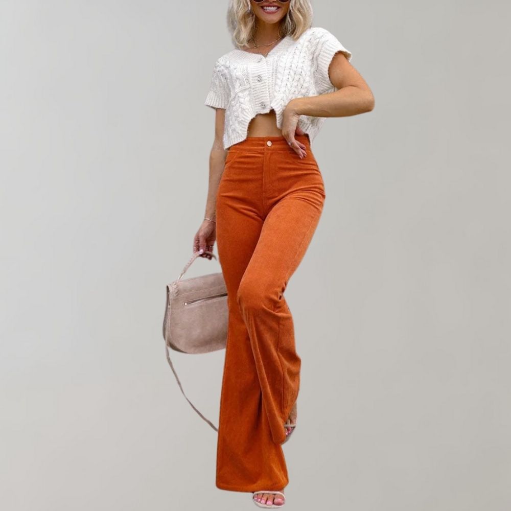 A woman modeling high-waisted flared pants paired with a cropped knit top and a stylish handbag, showcasing the chic and versatile design of the Lila | Women's High-Waisted Flared Pants | Chic Corduroy Trousers.