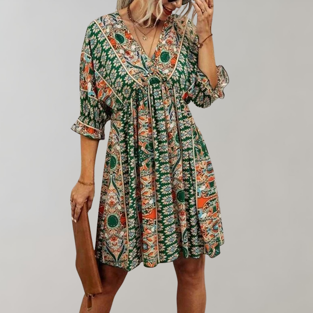Woman wearing a bohemian-style dress with a flowy fit, featuring intricate patterns and a casual, elegant design.