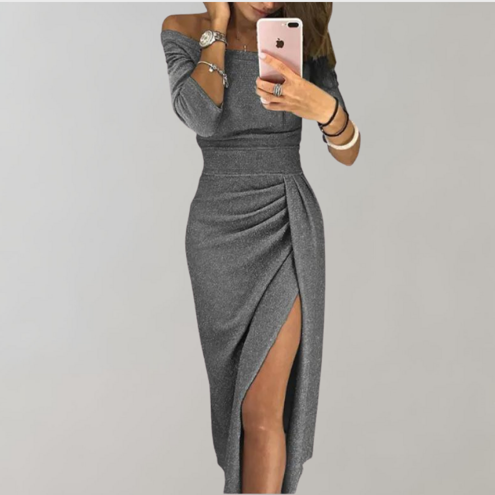 A model showcases the Scarlett | Off-Shoulder Ruched Slit Dress, featuring a flattering off-the-shoulder neckline, a ruched detail along the waist, and a high side slit for a sophisticated and elegant look. Ideal for special occasions.