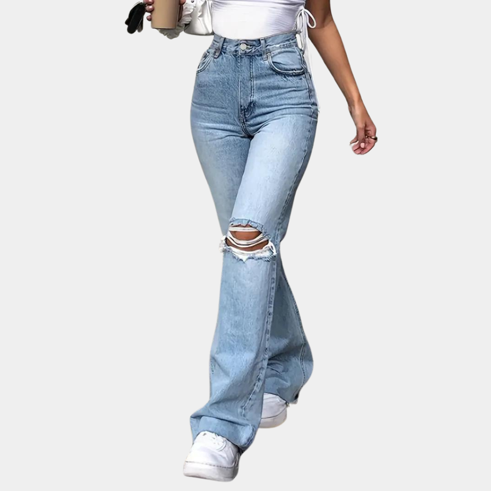 A stylish pair of high-waisted flared jeans featuring a distressed design on the knees, paired with a cropped top and casual sneakers, ideal for a chic and modern casual look.