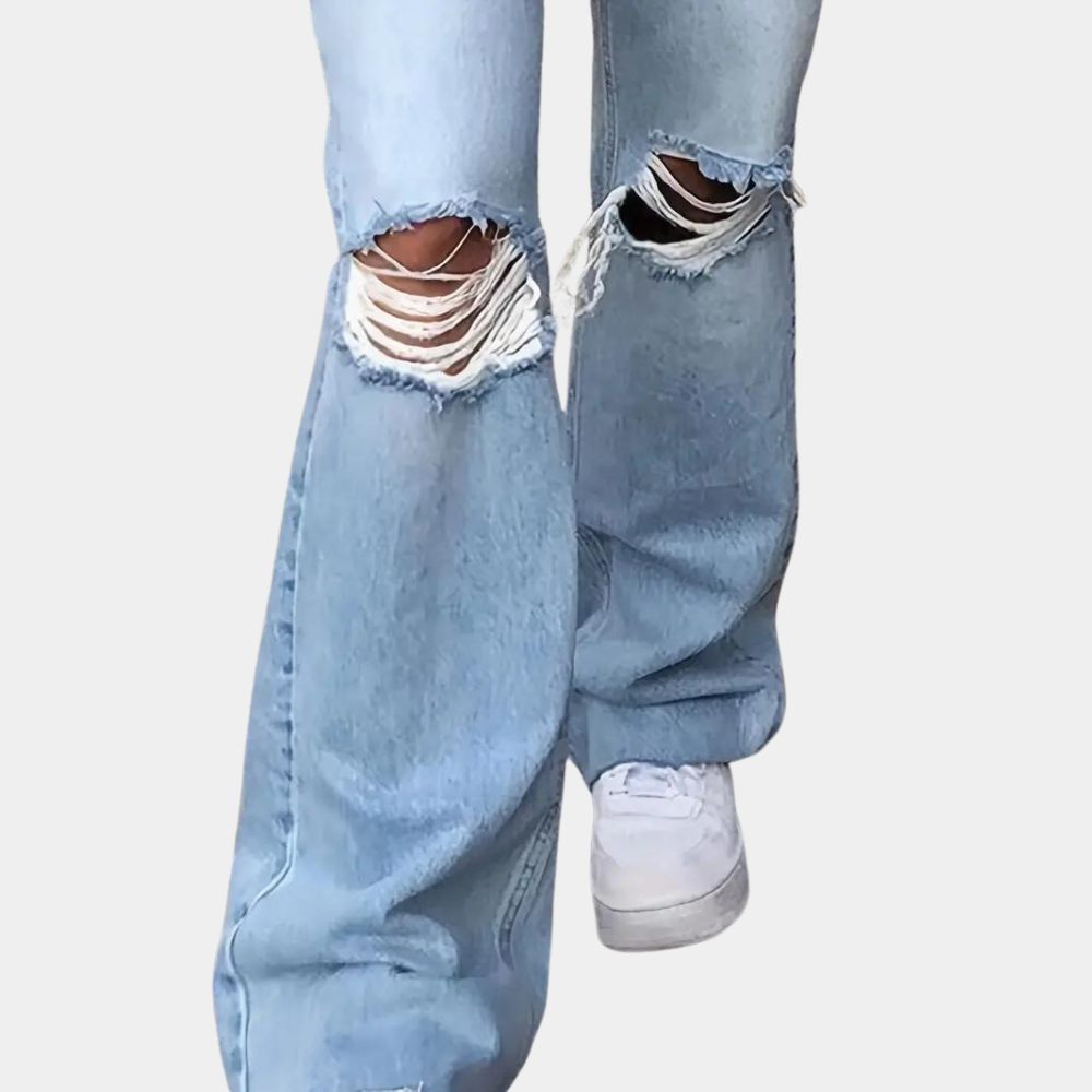 A stylish pair of high-waisted flared jeans featuring a distressed design on the knees, paired with a cropped top and casual sneakers, ideal for a chic and modern casual look.