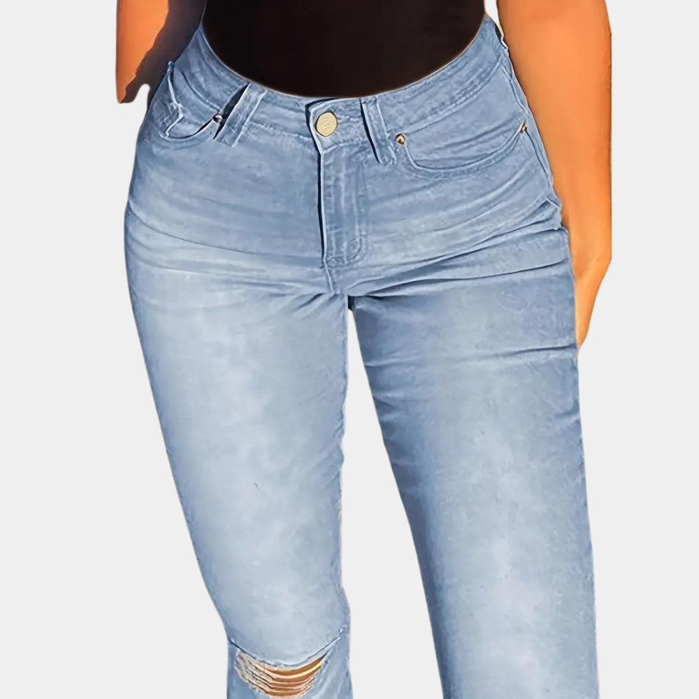 A stylish pair of high-waisted flared jeans featuring a distressed design on the knees, paired with a cropped top and casual sneakers, ideal for a chic and modern casual look.