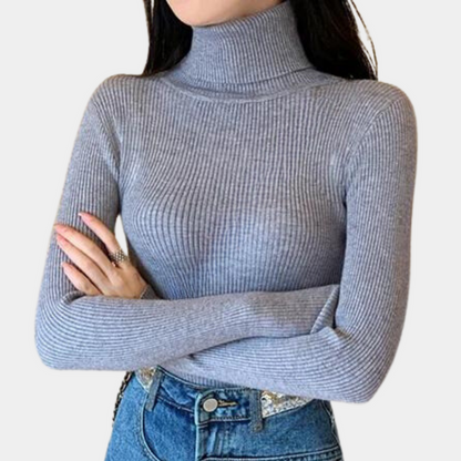 Model wearing the Sophia Women's Ribbed Turtleneck Top, showcasing its sleek, slim-fit design and high turtleneck style, paired with casual jeans.