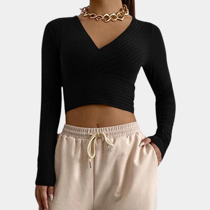 Model wearing the Ava | Long Sleeve Wrap Crop Top, featuring a flattering wrap design and long sleeves. Perfect for pairing with high-waisted pants or skirts, this versatile crop top offers a chic and comfortable look for any occasion.