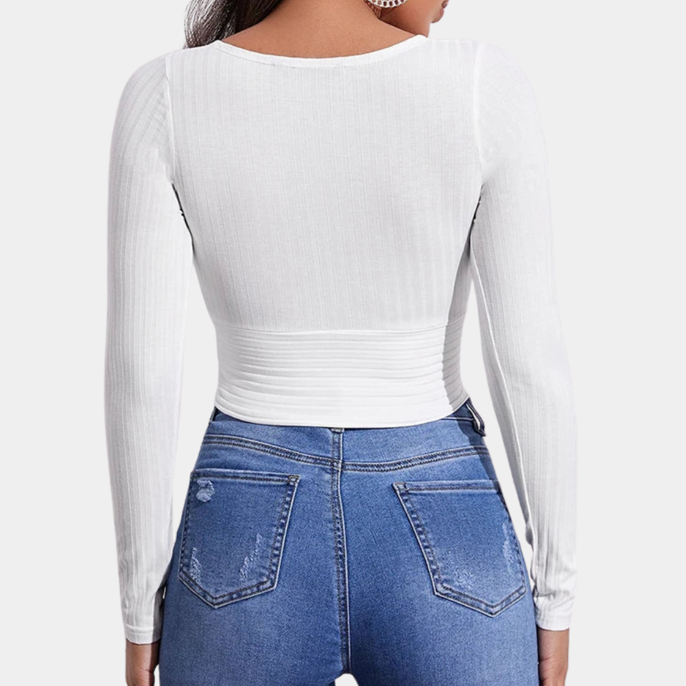 Model wearing the Ava | Long Sleeve Wrap Crop Top, featuring a flattering wrap design and long sleeves. Perfect for pairing with high-waisted pants or skirts, this versatile crop top offers a chic and comfortable look for any occasion.