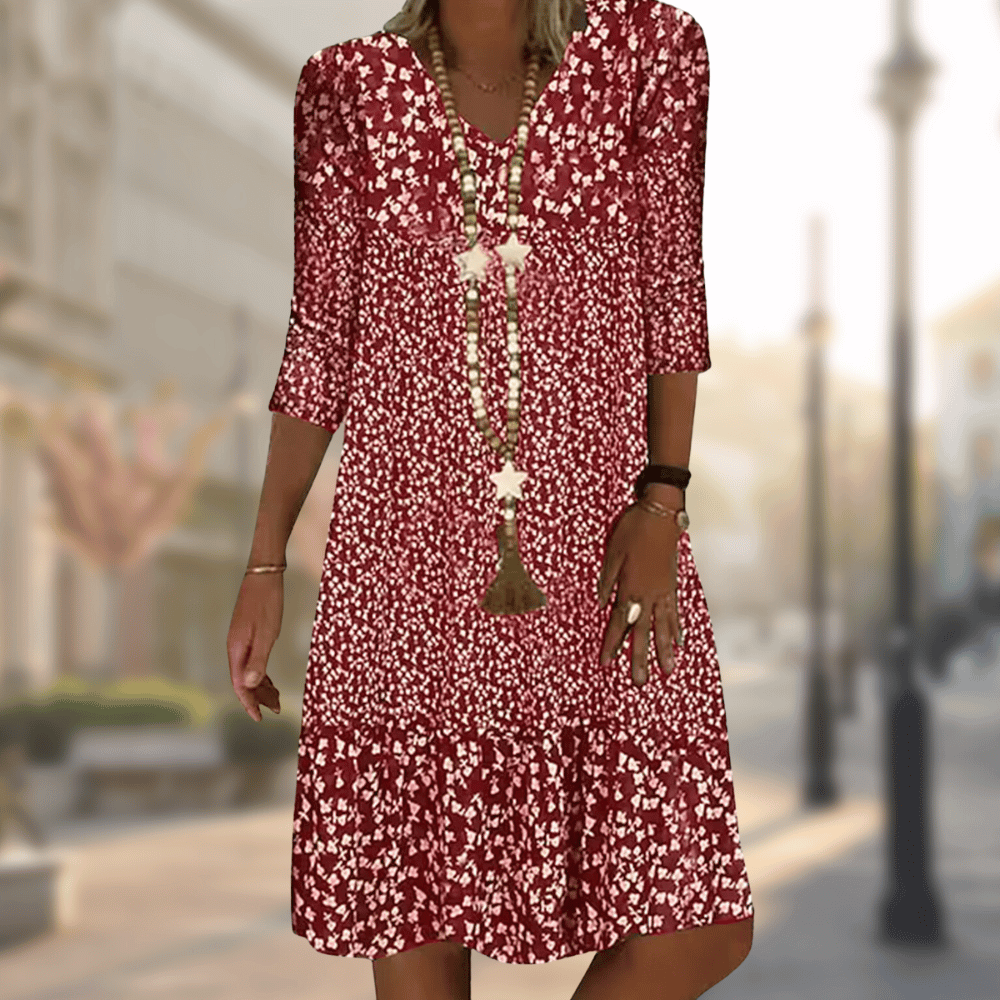 A woman wearing the Lila Women's Floral Midi Dress, featuring a boho chic style with a floral pattern and relaxed fit. The dress has three-quarter sleeves and a flowing silhouette, perfect for casual outings or beach-inspired looks.