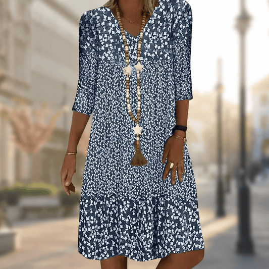 A woman wearing the Lila Women's Floral Midi Dress, featuring a boho chic style with a floral pattern and relaxed fit. The dress has three-quarter sleeves and a flowing silhouette, perfect for casual outings or beach-inspired looks.