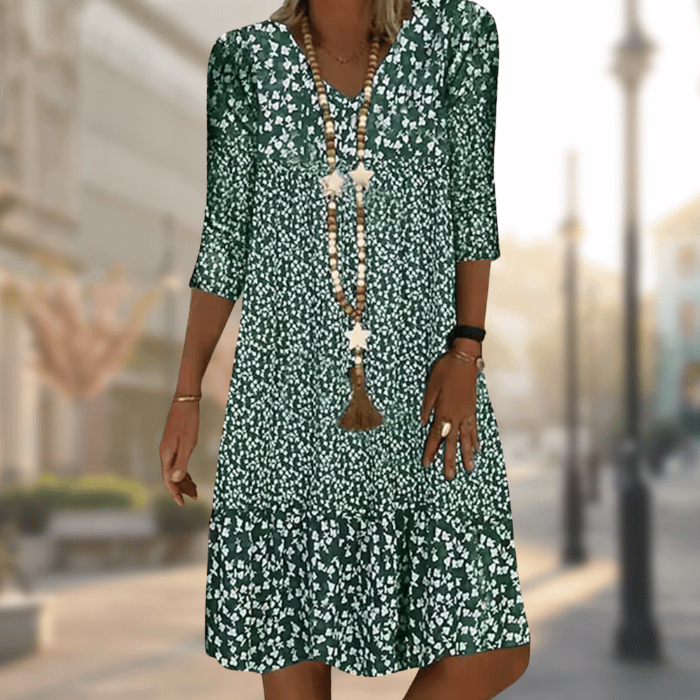 A woman wearing the Lila Women's Floral Midi Dress, featuring a boho chic style with a floral pattern and relaxed fit. The dress has three-quarter sleeves and a flowing silhouette, perfect for casual outings or beach-inspired looks.