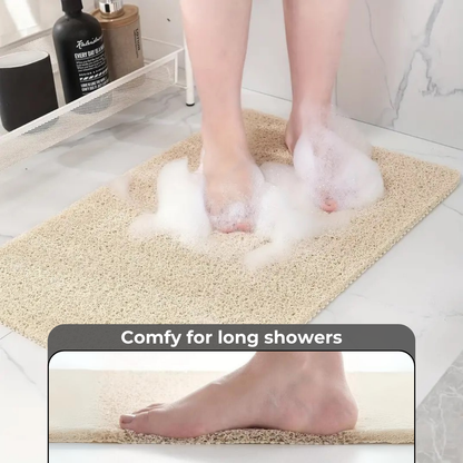  A bathroom anti-slip mat placed near a shower with a person stepping onto it, featuring a quick-dry design and textured surface for enhanced grip and safety.