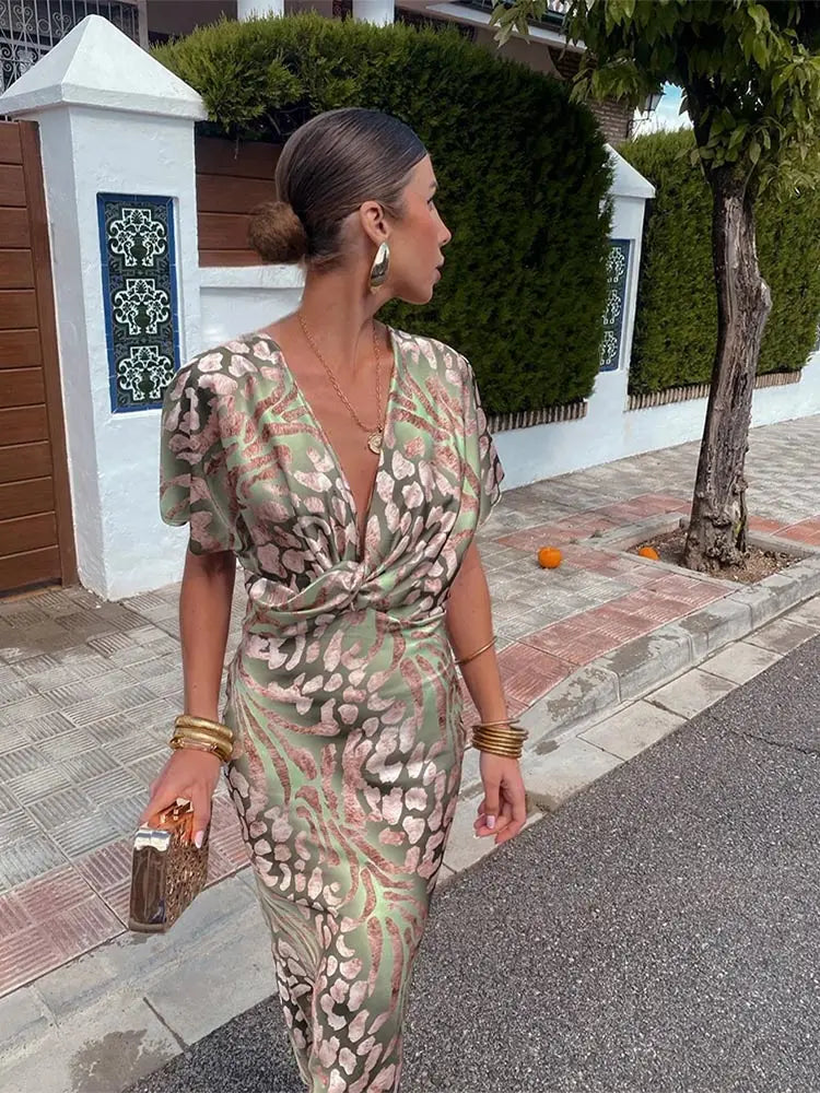 A woman wearing the Livia Women's Elegant Wrap Dress, featuring a luxurious wrap design with flowing short sleeves and a flattering silhouette. This luxe dress is perfect for upscale events or formal gatherings, showcasing sophisticated elegance and effortless style.
